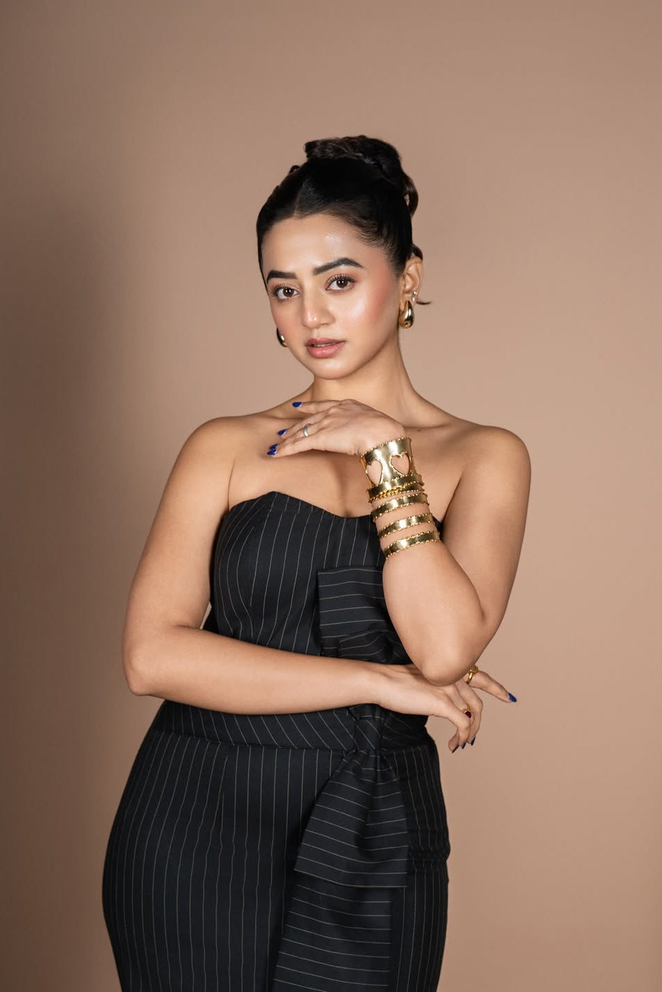 Helly Shah in Strapless Sweetheart Dress in Midnight Noir with pinstripes