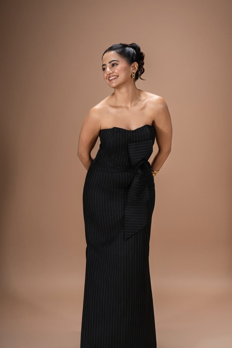 Helly Shah in Strapless Sweetheart Dress in Midnight Noir with pinstripes