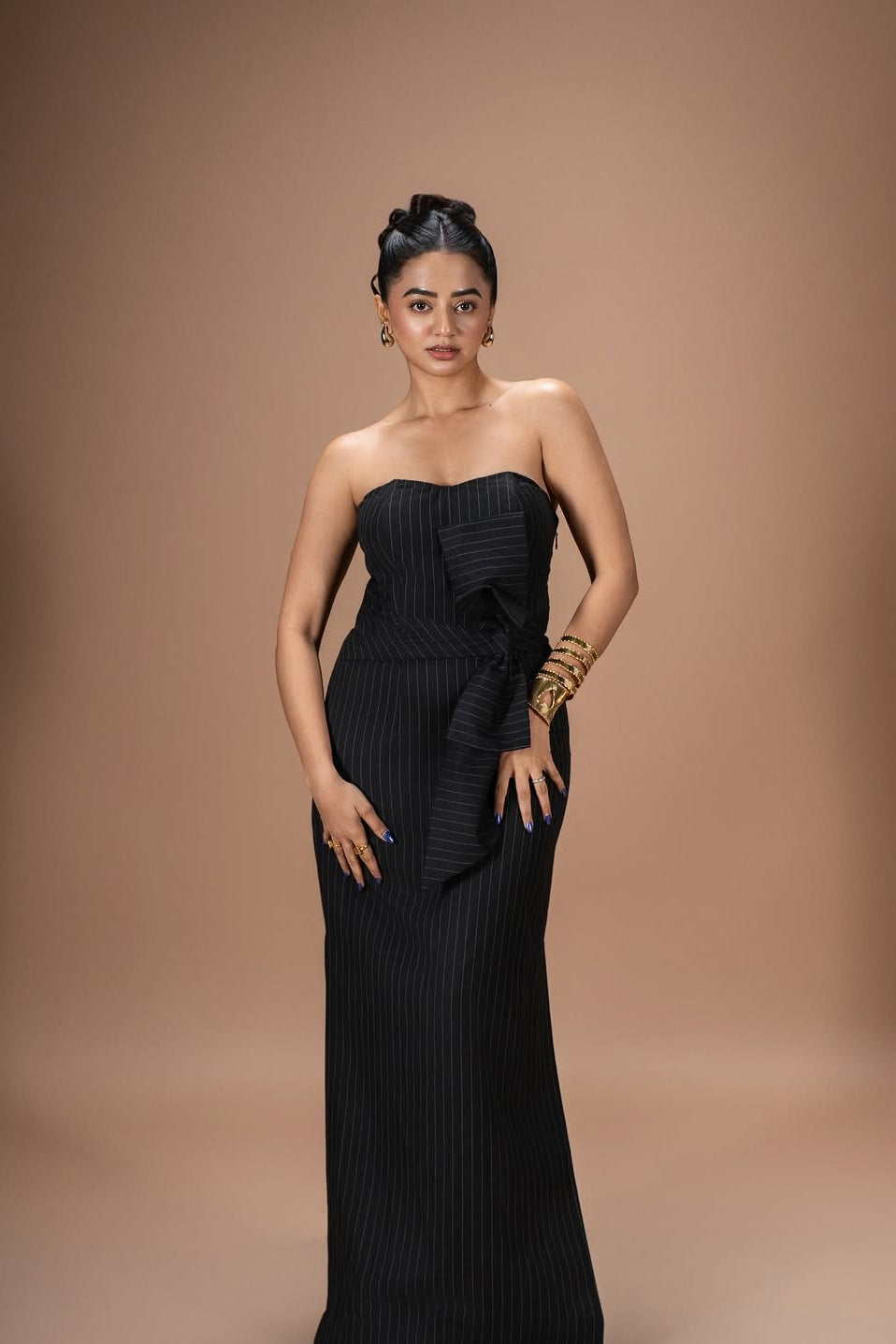 Helly Shah in Strapless Sweetheart Dress in Midnight Noir with pinstripes