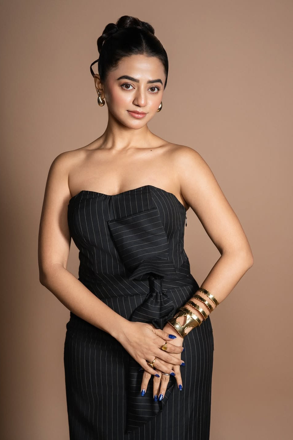 Helly Shah in Strapless Sweetheart Dress in Midnight Noir with pinstripes